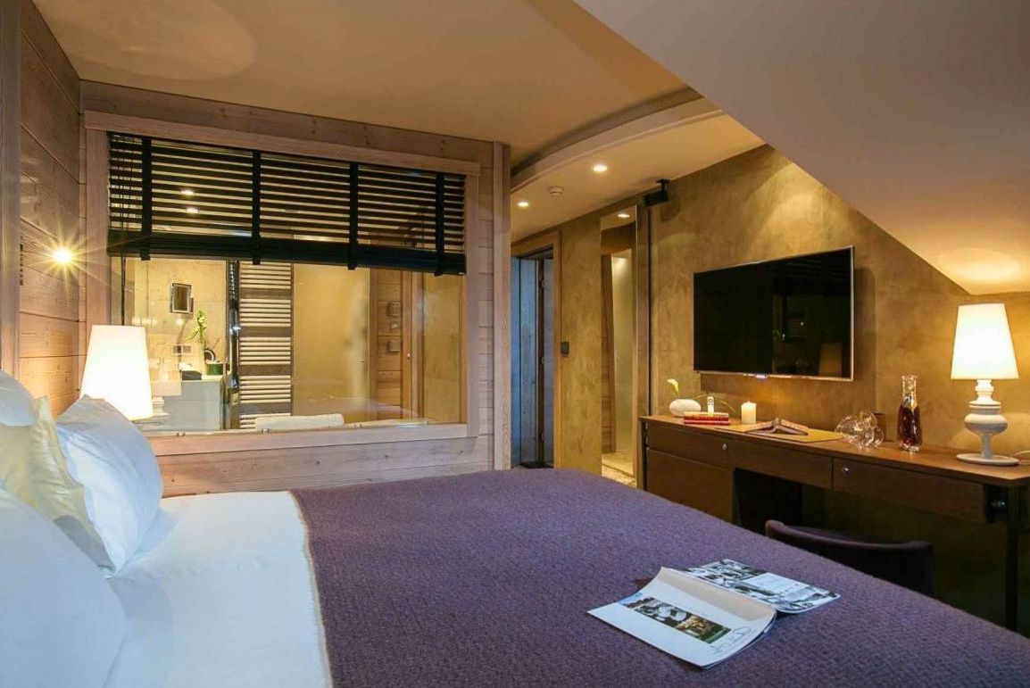 Deluxe room with king bed and lake-facing balcony at Joynexa hotel