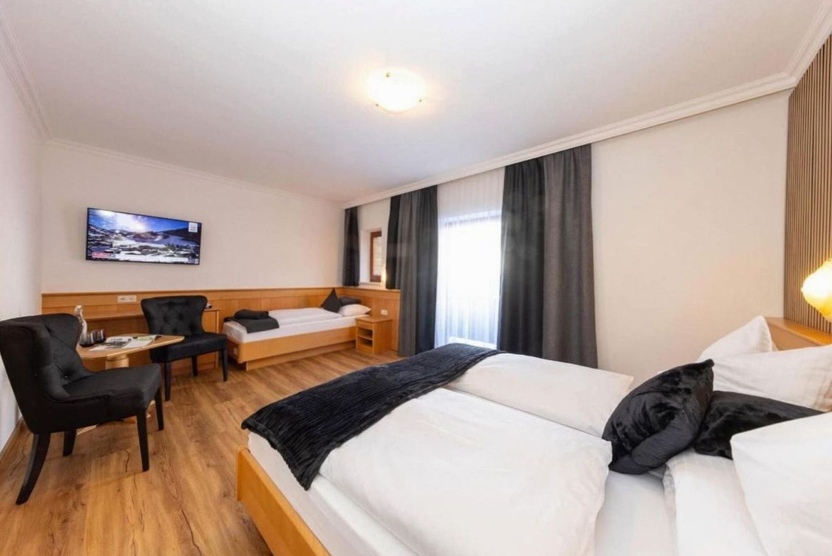 Luxury suite with freestanding bath and panoramic mountain windows at Joynexa hotel